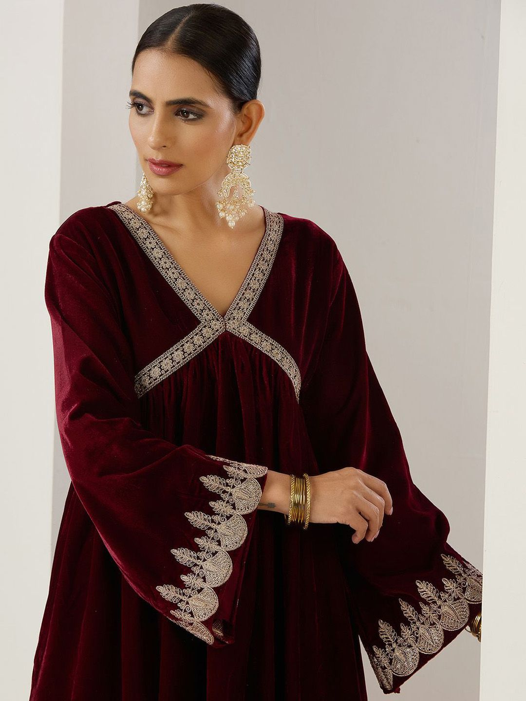 Rich Velvet Gold Zari Embroidered Burgundy A-Line Kurta Set with Straight Bottom & Scalloped Sleeves.